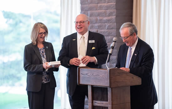 Valerie Wise and Dave Franson laugh after receipt of small gifts from Wichita Aero Club speaker David Olive | Photo: Visual Media Group.