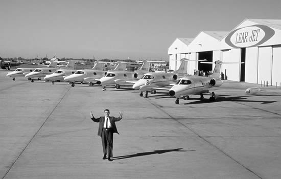 Lear holds up seven fingers announcing the completion of seven Learjet 23s, 1965.