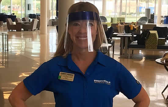 Amy Vaughn Deahl, director of student union operations and events, models a face shield manufactured by students on Embry-Riddle’s Daytona Beach Campus