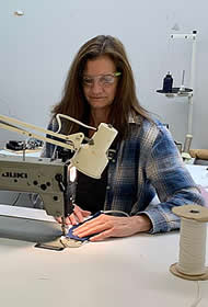 Duncan Aviation Upholstery Team Leader Kathy Wills works on sewing face masks to help prevent spread of COVID-19.