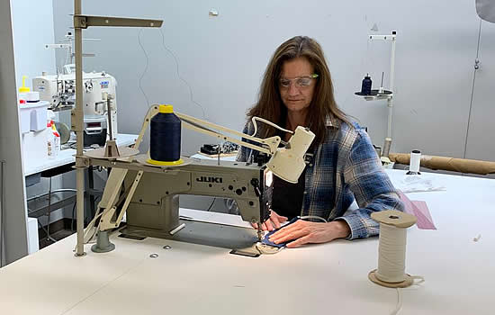 Duncan Aviation Upholstery Team Leader Kathy Wills works on sewing face masks to help prevent spread of COVID-19.