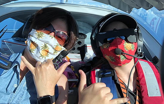 Nobi Buntin (left) and Abigail Dang enroute flying masks and supplies from Honolulu to Hilo in Czech Sport SportCruiser.