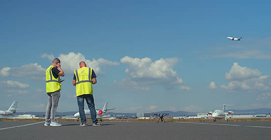 A drone pilot and test observer on the apron at Frankfurt Airport with a Yuneec drone