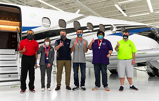Textron Aviation President & CEO Ron Draper (pictured third from left) with Special Olympics Kansas athletes.