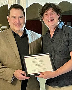 AIN's Curt Epstein (left) receives his award from Seth Miller.