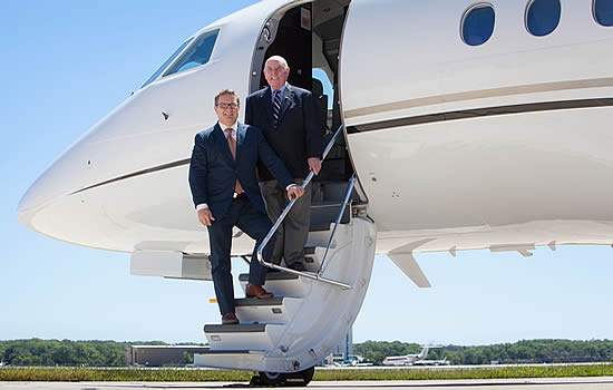 Andy Priester, President and CEO (bottom of stairs), will become its Chairman, taking over from Charlie Priester, who remains with Priester Aviation as Chairman Emeritus.