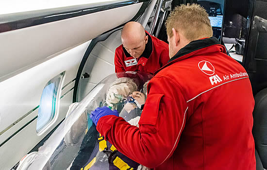 FAI Air Ambulance supports a patient using the EpiShuttle isolation pod.