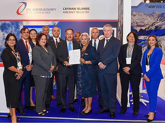 Director-General, Mr. Richard Smith presenting Julyn Tan, Accountable Manager of TAG Cayman (SEZC) with the Air Operators Certificate (AOC) surrounded by representatives of the CAACI, the C.I. Government, TAG Aviation and CEC.