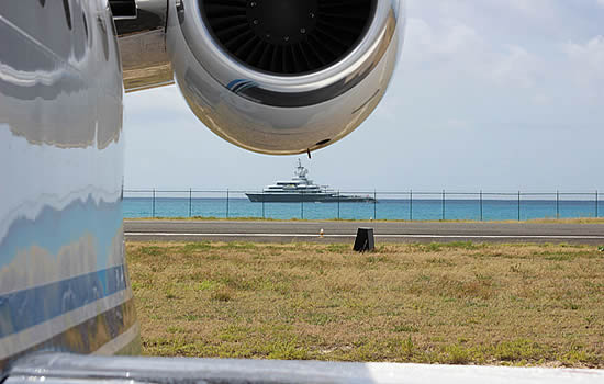 A business jet parked at SXM as a yacht gets underway to St. Barth. Photo:Kathryn B. Creedy.