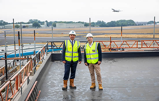 Steven Thorne-Farrar, General Manager of The Landing Hotel (L) and Bob Steward, Joint Managing Director of Barnes Construction (R) on the roof of the Landing Hotel at London Biggin Hill Airport.