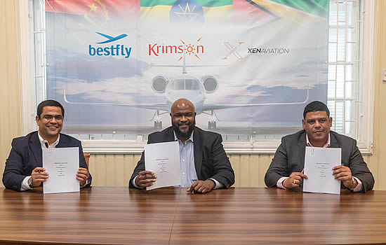 (L to R): Nuno Pereira and Morry Davis of Krimson Aviation sign with Ronaldo Alphonso, Xen Aviation.