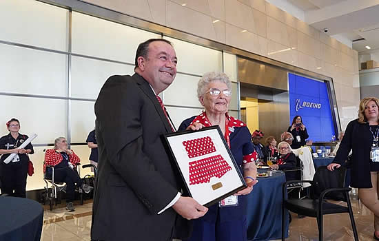 Ziad Ojakli, executive vice president of Government Operations, presents Boeing retiree Mae Krier with the space-flown Rosie mask and bandana. (Boeing photo)