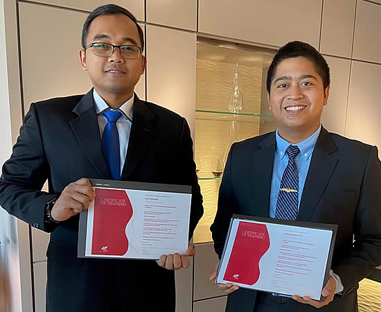 Two pilots from the Indonesian Air Force proudly displaying their certificates at a Dassault celebratory ceremony.