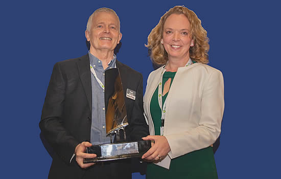 Marc Bailey receives the Outstanding Contribution to Aviation Award from Aoife O'Sullivan