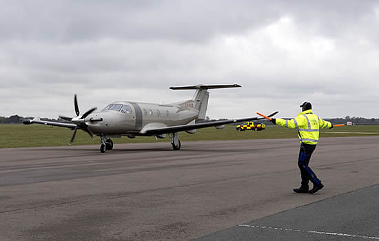 Marshalling a JetFly PC-12 at London Oxford Airport.