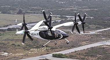 Joby test pilot James “Buddy” Denham flying a fully transitioned Joby aircraft above the company’s facilities in Marina, California