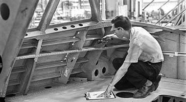 A Boeing inspector examines the interior structure of a 747 fuselage in 1968.