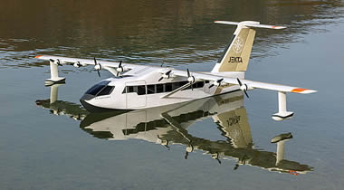 The PHA-ZE 100 1:9 scale model showcases how the amphibious aircraft will alight on its flying-boat hull, supported by underwing outrigger floats. The full-size aircraft will include retractable wheeled undercarriage for amphibious operations.